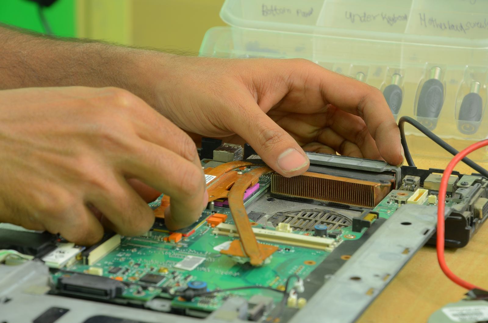 Computer repair workbench with open desktop PC and repair tools